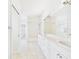 Bright, neutral bathroom with tile flooring, double vanity, and combination shower and tub at 10169 Holly Berry Dr, Weeki Wachee, FL 34613