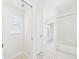 Bright, neutral bathroom with a combination shower and tub with tile flooring at 10169 Holly Berry Dr, Weeki Wachee, FL 34613