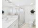 Bright bathroom featuring a glass shower, tile flooring, and a white vanity with a sink at 10169 Holly Berry Dr, Weeki Wachee, FL 34613