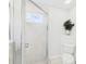 Bathroom with tile flooring, a glass shower enclosure, and a white toilet with green foliage at 10169 Holly Berry Dr, Weeki Wachee, FL 34613