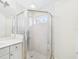 Well-lit bathroom featuring tile flooring, shower with glass enclosure, and a white vanity at 10169 Holly Berry Dr, Weeki Wachee, FL 34613