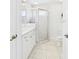 Bright bathroom with double sinks, granite countertop and a tiled glass shower at 10169 Holly Berry Dr, Weeki Wachee, FL 34613