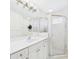 Bright bathroom with double sinks, granite countertop and a tiled glass shower at 10169 Holly Berry Dr, Weeki Wachee, FL 34613