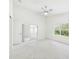 Bright bedroom with a ceiling fan, window, and sliding glass door leading to an outdoor space at 10169 Holly Berry Dr, Weeki Wachee, FL 34613
