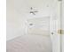 Carpeted bedroom with a doorway, windows with blinds, and a ceiling fan, with an ample source of natural light at 10169 Holly Berry Dr, Weeki Wachee, FL 34613