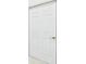 A clean white six-panel door with brushed brass hardware at 10169 Holly Berry Dr, Weeki Wachee, FL 34613