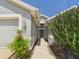 Close-up of the green front door, landscaping, and the two car attached garage at 10169 Holly Berry Dr, Weeki Wachee, FL 34613