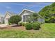 Attractive single-story home featuring a well-kept lawn, mature landscaping, and a two-car garage at 10169 Holly Berry Dr, Weeki Wachee, FL 34613
