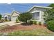 Attractive single-story home featuring a well-kept lawn, mature landscaping, and a two-car garage at 10169 Holly Berry Dr, Weeki Wachee, FL 34613
