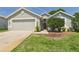 Charming single story home with a two car garage, manicured lawn, and a cozy front porch at 10169 Holly Berry Dr, Weeki Wachee, FL 34613