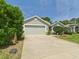Charming single story home with a two car garage, manicured lawn, and a cozy front porch at 10169 Holly Berry Dr, Weeki Wachee, FL 34613