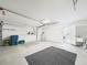 Open garage with shelving, utility sink, overhead light, and access door at 10169 Holly Berry Dr, Weeki Wachee, FL 34613