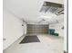 Open garage featuring shelving and overhead door with natural light at 10169 Holly Berry Dr, Weeki Wachee, FL 34613