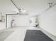 Open garage with shelving, utility sink, overhead light, and access door at 10169 Holly Berry Dr, Weeki Wachee, FL 34613