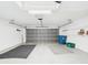 Open garage featuring shelving and overhead door with natural light at 10169 Holly Berry Dr, Weeki Wachee, FL 34613