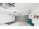 Open garage featuring shelving and overhead door with natural light at 10169 Holly Berry Dr, Weeki Wachee, FL 34613