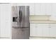 Kitchen area with stainless steel refrigerator and white cabinets at 10169 Holly Berry Dr, Weeki Wachee, FL 34613