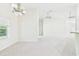 Expansive living area featuring a neutral color scheme and multiple ceiling fans at 10169 Holly Berry Dr, Weeki Wachee, FL 34613