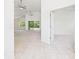 Open-concept living room featuring neutral carpet, ceiling fans, and sliding glass doors to the lanai at 10169 Holly Berry Dr, Weeki Wachee, FL 34613