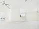 Open concept living room featuring laundry area and ceiling fans at 10169 Holly Berry Dr, Weeki Wachee, FL 34613