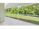 Screened-in patio overlooking a lush green backyard providing a serene outdoor space at 10169 Holly Berry Dr, Weeki Wachee, FL 34613