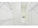 Bright walk-in closet with metal shelving on white walls and carpeted floor at 10169 Holly Berry Dr, Weeki Wachee, FL 34613