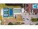 An aerial view showcases the community's tennis and shuffleboard courts, swimming pool, and parking at 341 Outrigger Pl, North Port, FL 34287
