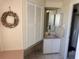Bathroom featuring a vanity with storage, a wall mirror, and a decorative starfish wreath at 341 Outrigger Pl, North Port, FL 34287