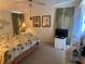 Relaxing bedroom with palm tree bedding, neutral walls, and soft, natural lighting at 341 Outrigger Pl, North Port, FL 34287