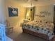 Bedroom featuring tropical themed bedding, and plenty of natural light at 341 Outrigger Pl, North Port, FL 34287