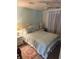 This bedroom includes a queen bed with light blue bedding and white nightstands at 341 Outrigger Pl, North Port, FL 34287