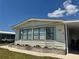 Charming home with great windows, pretty siding, and nice landscaping at 341 Outrigger Pl, North Port, FL 34287