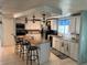Stylish kitchen featuring an island with seating, granite countertops, and modern appliances at 341 Outrigger Pl, North Port, FL 34287