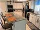 This kitchen is equipped with stainless steel appliances and a breakfast bar at 341 Outrigger Pl, North Port, FL 34287