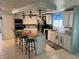Bright kitchen features a granite island with barstool seating and modern appliances at 341 Outrigger Pl, North Port, FL 34287