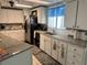 This kitchen offers granite counters, tile backsplash, stainless steel refrigerator, and ample storage at 341 Outrigger Pl, North Port, FL 34287