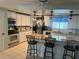 The kitchen features an island with seating, and great lighting at 341 Outrigger Pl, North Port, FL 34287