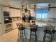The kitchen features an island with seating, and great lighting at 341 Outrigger Pl, North Port, FL 34287