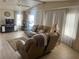 Relaxing living room with ample seating, soft textures, and bright natural light at 341 Outrigger Pl, North Port, FL 34287