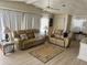 Living room featuring comfortable seating, a ceiling fan, and lots of natural light at 341 Outrigger Pl, North Port, FL 34287