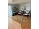 Living room with bright blue walls and decor, tile floors, and decorative rug at 341 Outrigger Pl, North Port, FL 34287