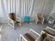 Enclosed patio features comfortable seating and a neutral color palette at 341 Outrigger Pl, North Port, FL 34287