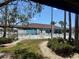 A view of the community pool with lounge chairs and tropical landscaping surrounding it at 341 Outrigger Pl, North Port, FL 34287