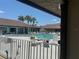 A view of the community pool with lounge chairs and people enjoying a swim on a sunny day at 341 Outrigger Pl, North Port, FL 34287