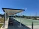 Exterior view of the shuffleboard courts with covered seating areas at 341 Outrigger Pl, North Port, FL 34287