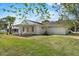 Expansive backyard with a covered patio, offering ample space for recreation at 1103 W Dixie St, Plant City, FL 33563