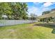 Large, fenced backyard featuring a covered patio and plenty of green space at 1103 W Dixie St, Plant City, FL 33563