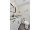 Modern bathroom featuring granite counters, black fixtures, and wood-look flooring at 1103 W Dixie St, Plant City, FL 33563