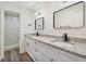 Modern bathroom with dual vanity sinks, granite countertop, and a walk-in shower at 1103 W Dixie St, Plant City, FL 33563