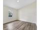 Comfortable bedroom with wood flooring and a window offering a view of the outdoors at 1103 W Dixie St, Plant City, FL 33563